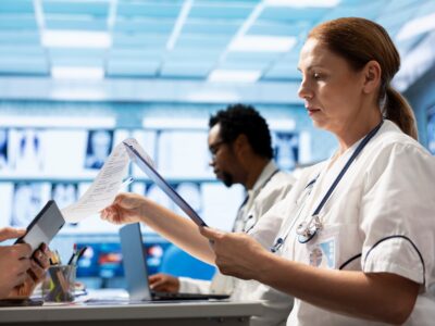 Doctors meet to discuss healthcare records and x ray scans results at a treatment center. Licensed medics focus on medical tests for disease prevention, demonstrating teamwork and expertise.
